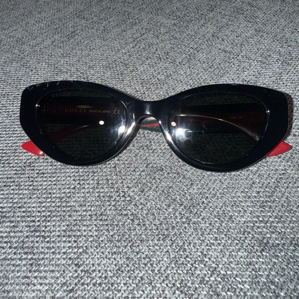 Gucci Black and Red Oval Sunglasses with Glossy Finish